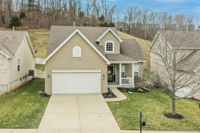 view of front of house with a garage, a front yard, central AC unit, and covered porch