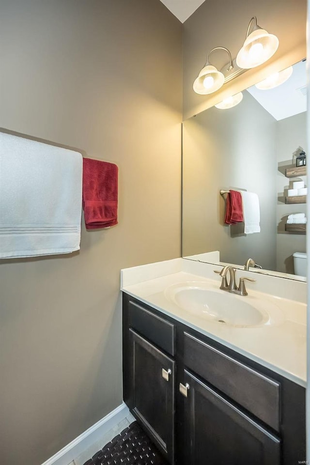 bathroom featuring vanity and toilet