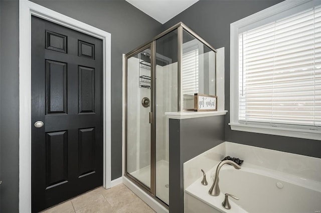 bathroom with tile patterned floors and shower with separate bathtub