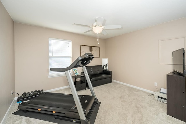 exercise area with ceiling fan and light colored carpet