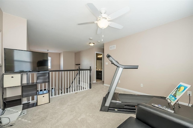 exercise room featuring light carpet and ceiling fan