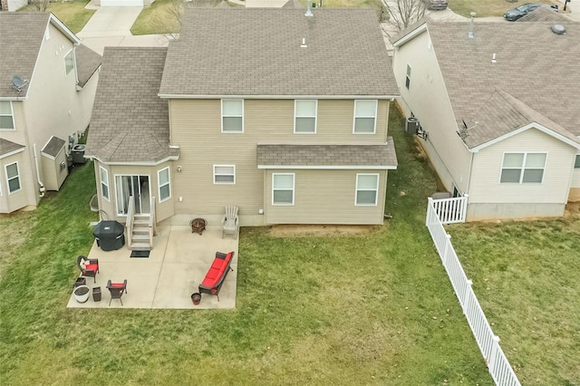 back of property featuring a yard and a patio area