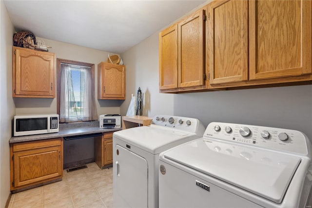 laundry area featuring cabinets, washing machine and clothes dryer, and light tile patterned flooring