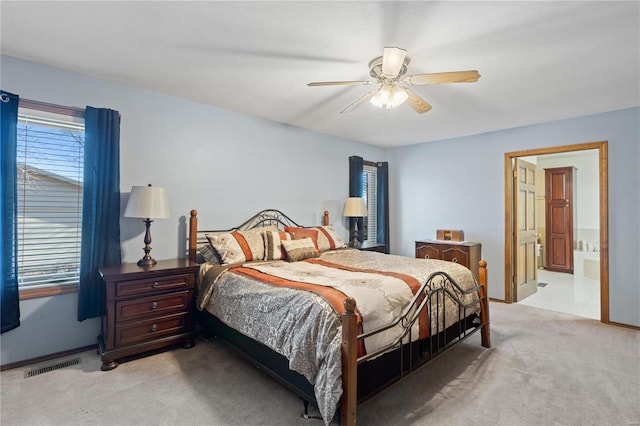 carpeted bedroom with ceiling fan and ensuite bathroom