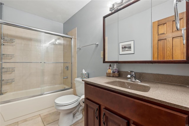 full bathroom with vanity, tile patterned floors, shower / bath combination with glass door, and toilet