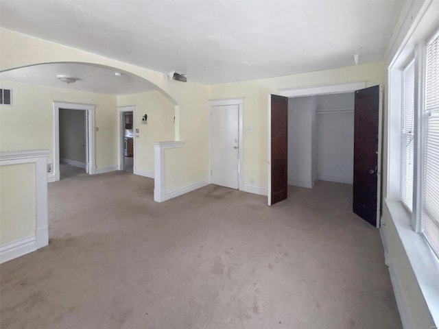 unfurnished living room featuring light colored carpet