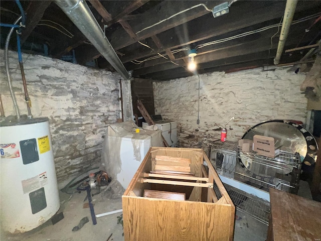 basement featuring water heater and independent washer and dryer