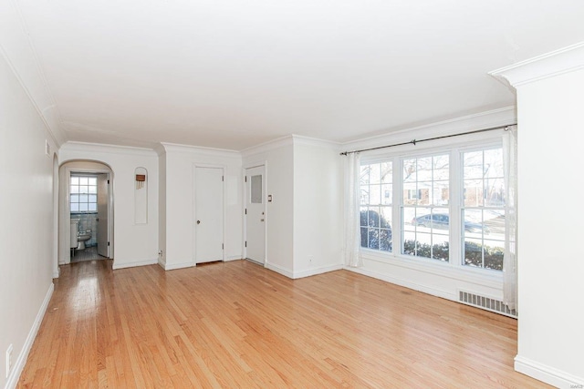 interior space with crown molding, a healthy amount of sunlight, and light hardwood / wood-style flooring