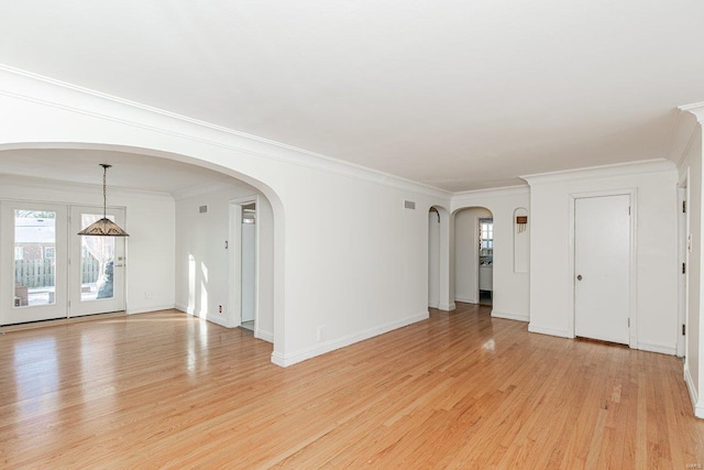 unfurnished room featuring ornamental molding, a healthy amount of sunlight, and light hardwood / wood-style floors