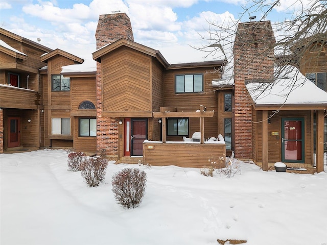 view of snow covered rear of property