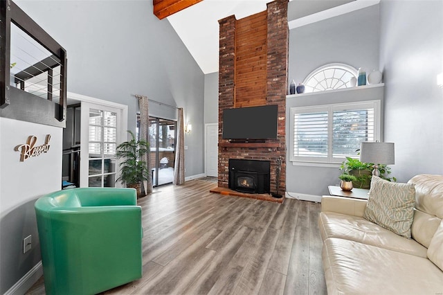 living room with beam ceiling, a brick fireplace, high vaulted ceiling, and hardwood / wood-style flooring