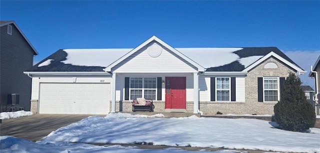 ranch-style house featuring central air condition unit and a garage