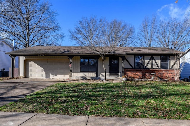 view of front of property featuring a front yard and a garage