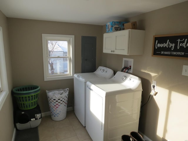 clothes washing area with light tile patterned flooring, cabinets, electric panel, and washing machine and dryer