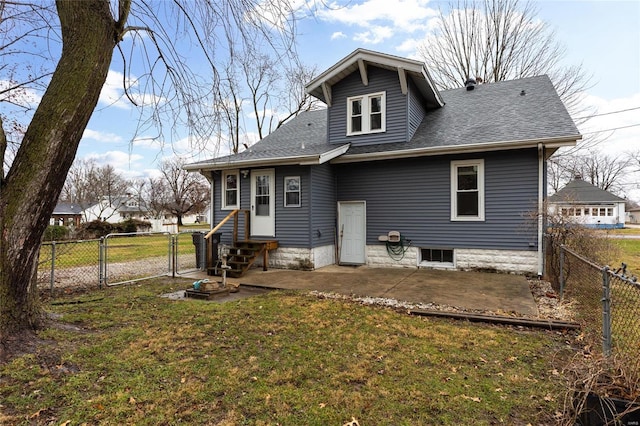 rear view of property with a lawn and a patio