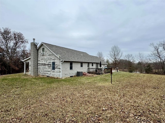 view of home's exterior featuring a deck, cooling unit, and a lawn