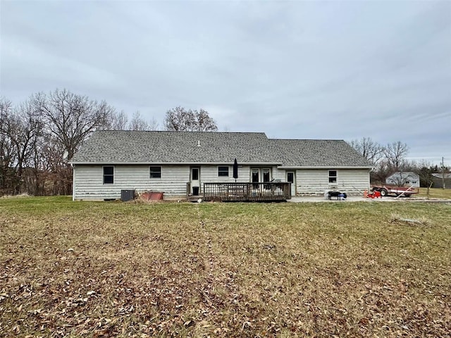 rear view of house featuring a yard and a deck