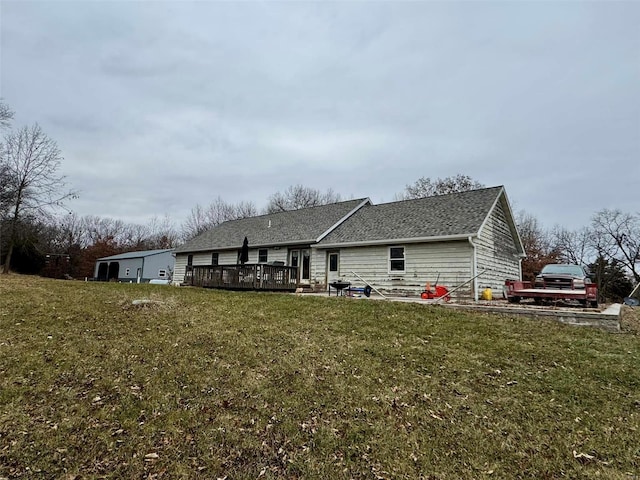 back of house featuring a wooden deck, a patio area, and a yard