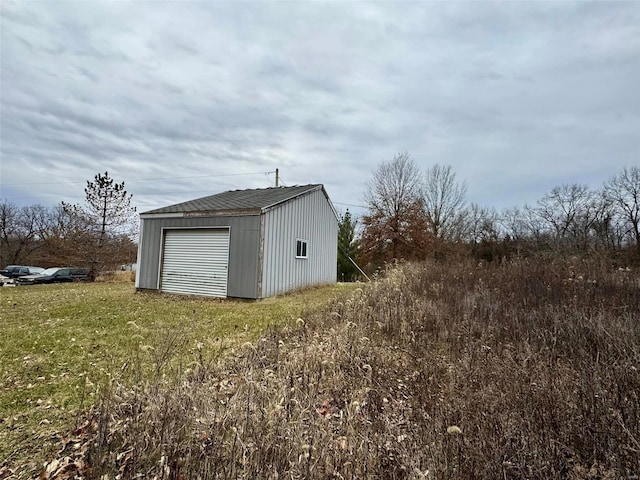 view of outdoor structure featuring a yard and a garage