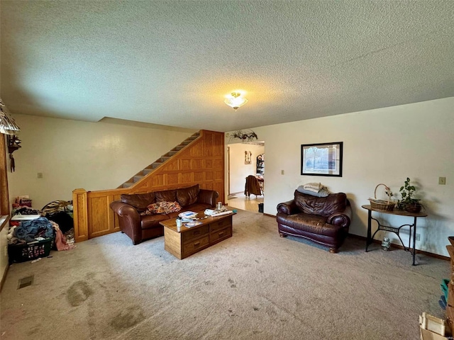 living room featuring light carpet and a textured ceiling