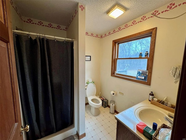 bathroom featuring walk in shower, vanity, a textured ceiling, and toilet