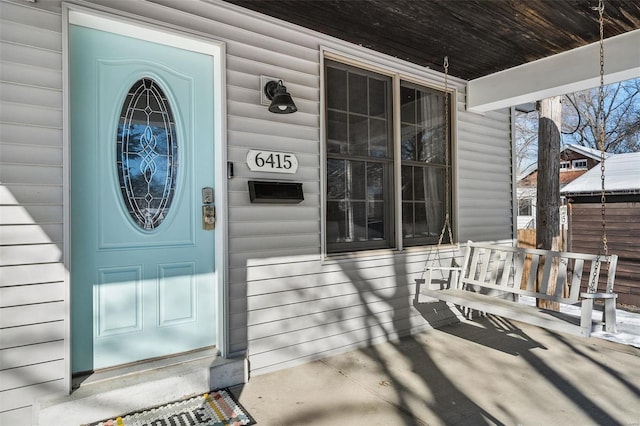 property entrance with covered porch