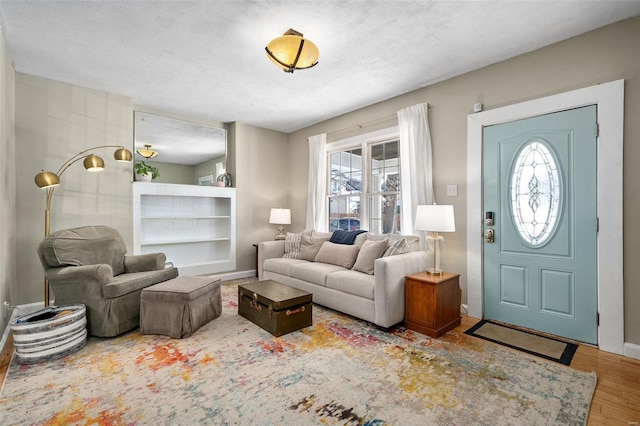 living room with a textured ceiling and hardwood / wood-style flooring