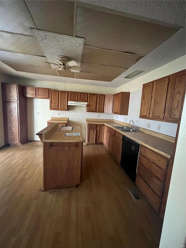 kitchen with sink, dishwasher, ceiling fan, a kitchen island, and dark wood-type flooring