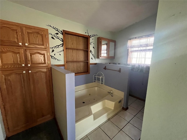 bathroom with lofted ceiling, tile patterned floors, and a bathing tub