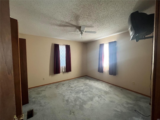 interior space featuring ceiling fan, a textured ceiling, and carpet flooring