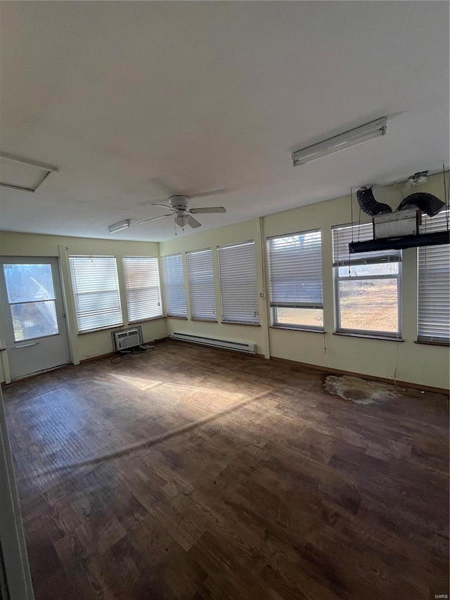 unfurnished sunroom with a wall mounted AC, ceiling fan, and a baseboard radiator