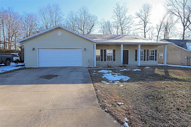 ranch-style house featuring covered porch and a garage