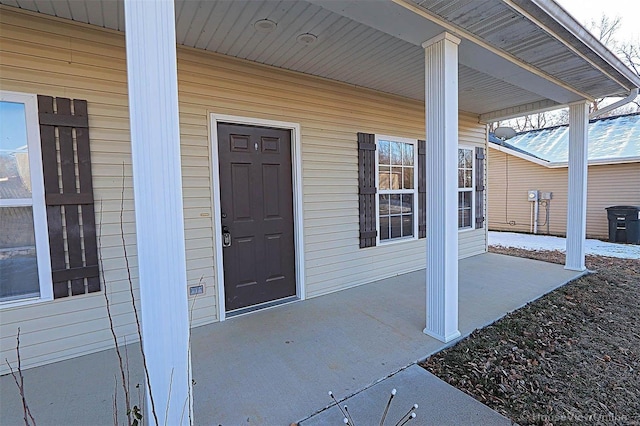 view of exterior entry with a porch