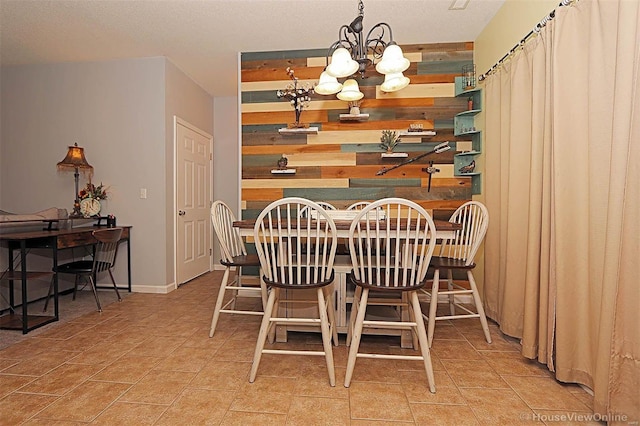 dining space with wooden walls and an inviting chandelier