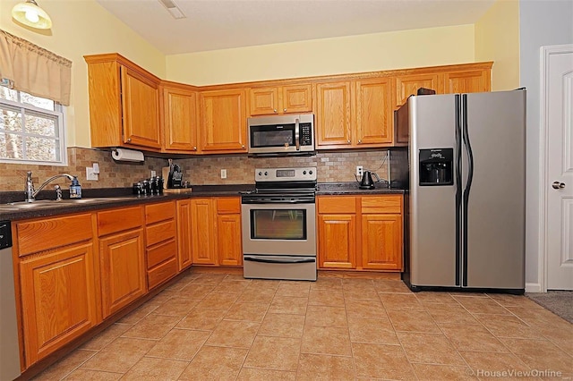 kitchen featuring sink, backsplash, and appliances with stainless steel finishes