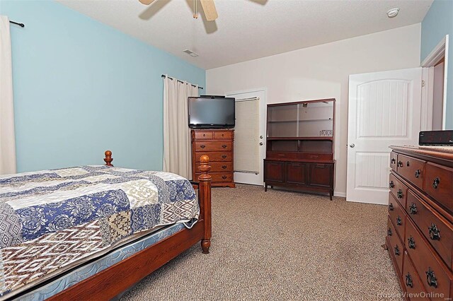 carpeted bedroom with ceiling fan