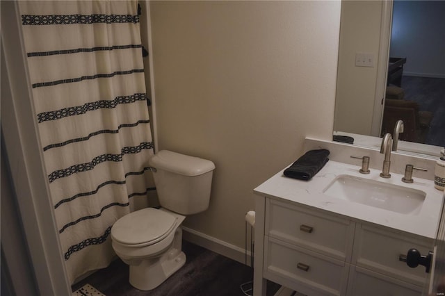 bathroom with toilet, a shower with curtain, vanity, and hardwood / wood-style floors