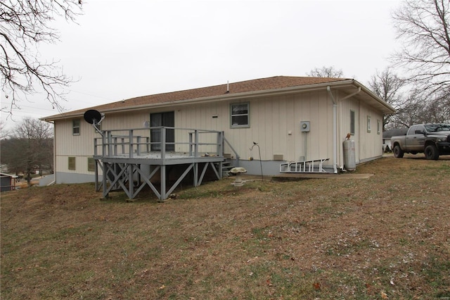 back of house featuring a yard and a deck