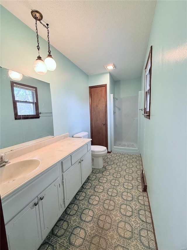 bathroom featuring vanity, a textured ceiling, toilet, and a shower