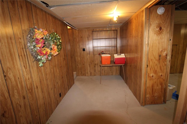 hallway featuring wooden walls