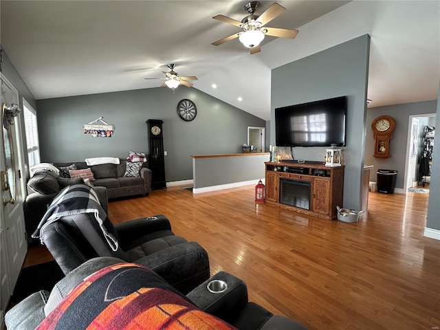 living room featuring hardwood / wood-style flooring, ceiling fan, and lofted ceiling