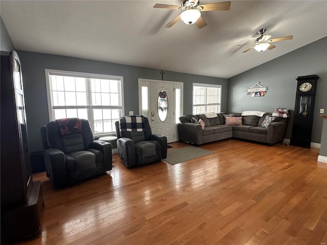 living room with hardwood / wood-style floors, ceiling fan, and lofted ceiling