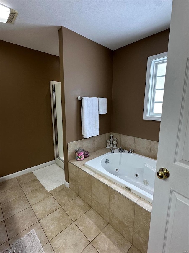 bathroom with tile patterned floors and separate shower and tub