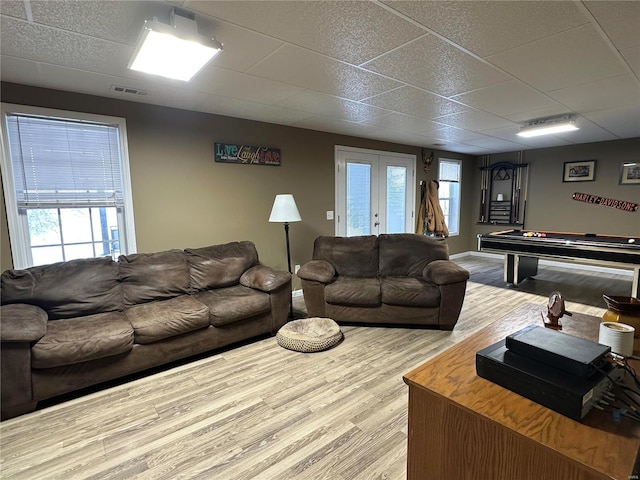 living room with light hardwood / wood-style floors, pool table, and french doors