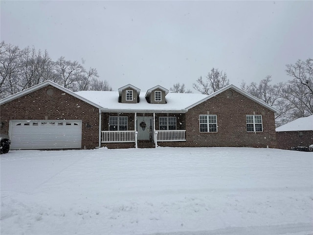 view of front of property featuring a porch and a garage