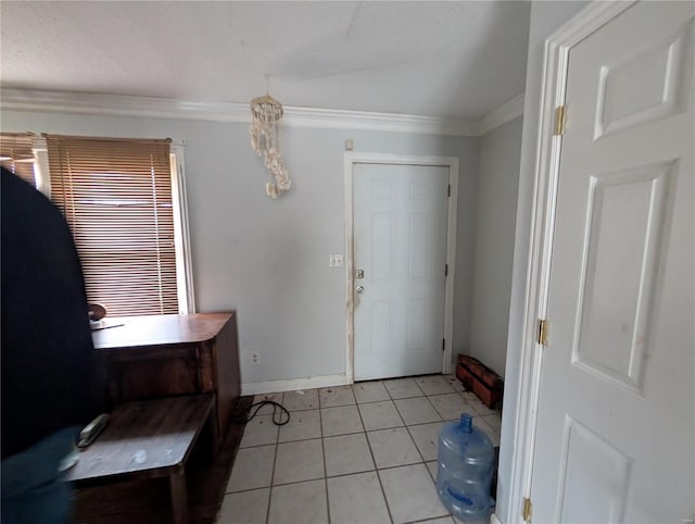 tiled entrance foyer featuring crown molding