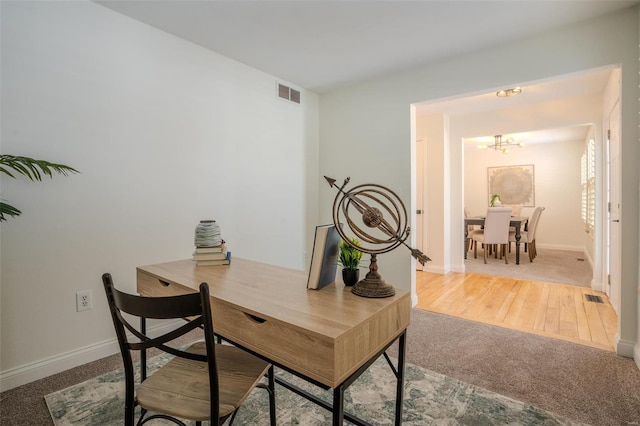 office area with carpet and an inviting chandelier