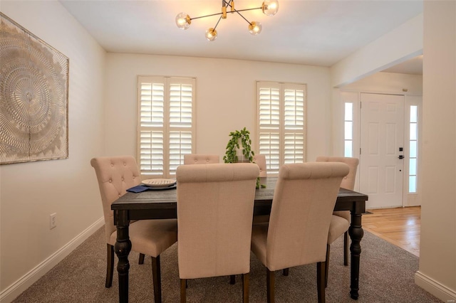 dining room featuring hardwood / wood-style flooring and a notable chandelier