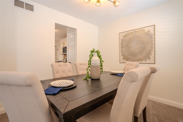 view of carpeted dining area