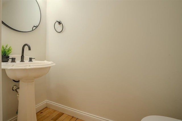 bathroom with wood-type flooring